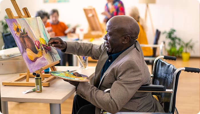 Stroke survivor engaging in painting as part of a rehabilitation program, promoting creativity and cognitive recovery.