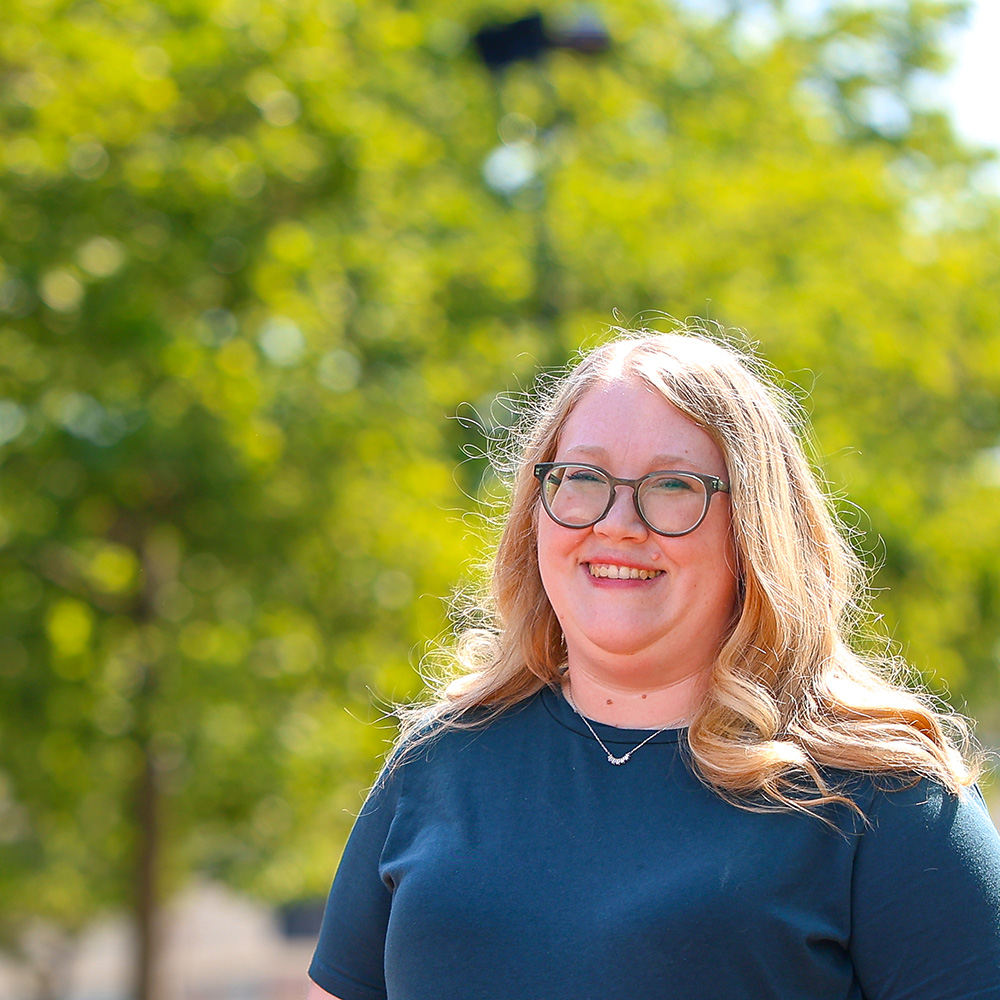 Close-up of Katherine, a stroke survivor, smiling outdoors, showing confidence and strength.