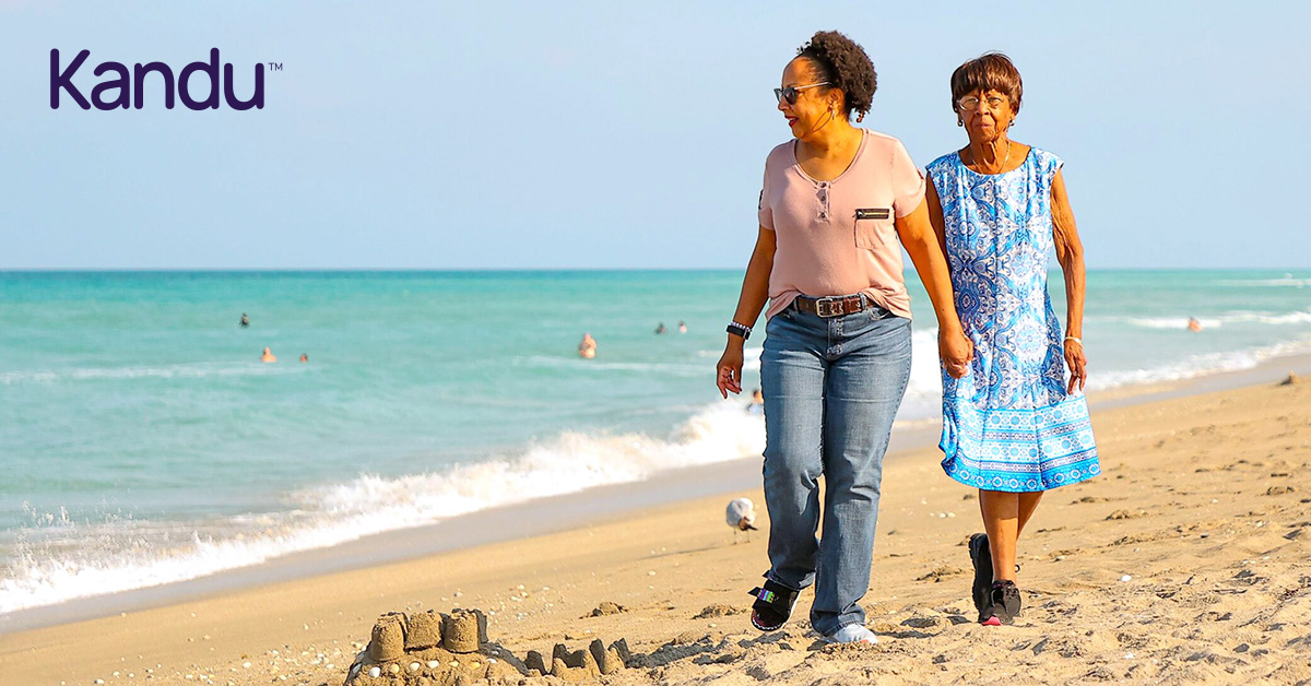 Cheryl, a stroke survivor and Kandu program graduate, walking on the beach with a friend.